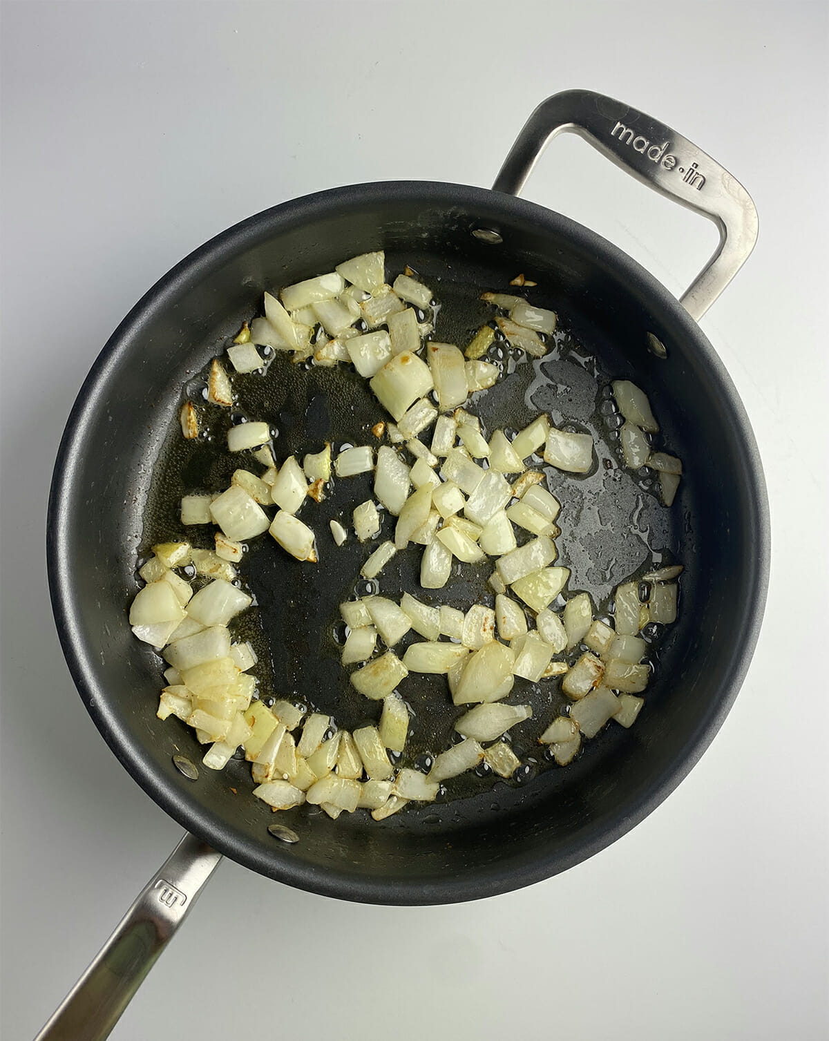 Sauteed onions in a frying pan.