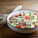 Greek grain salad in a bowl.