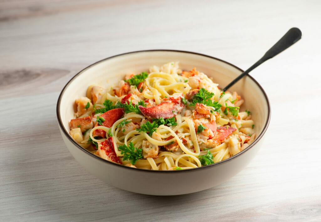 Lemon Garlic Lobster Pasta in a bowl with a fork.