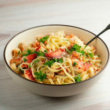 Lemon Garlic Lobster Pasta in a bowl with a fork.