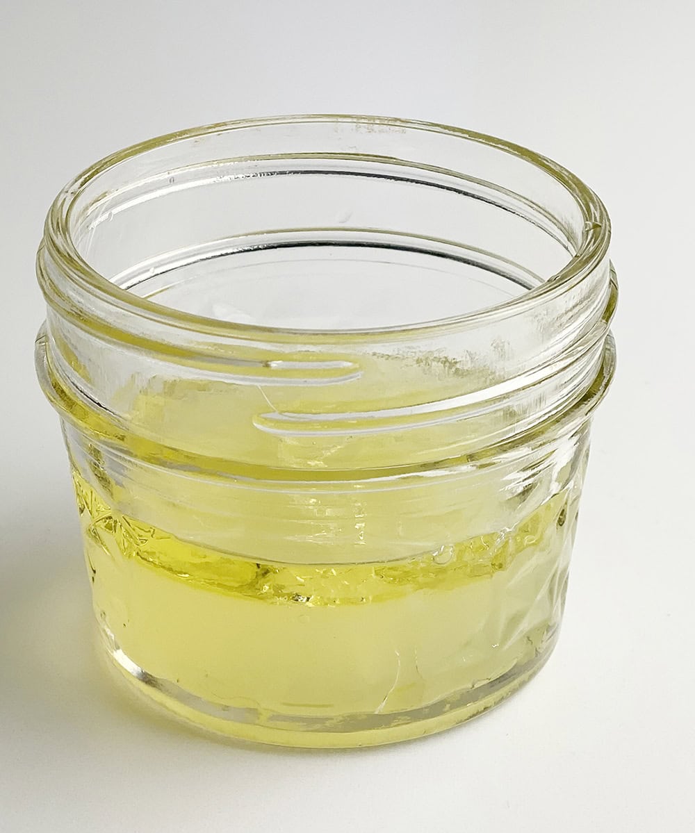 Lemon olive oil dressing in a jar.