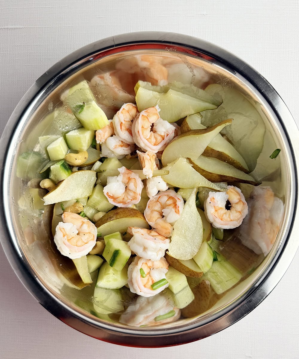 Tossed summer shrimp salad in a bowl.