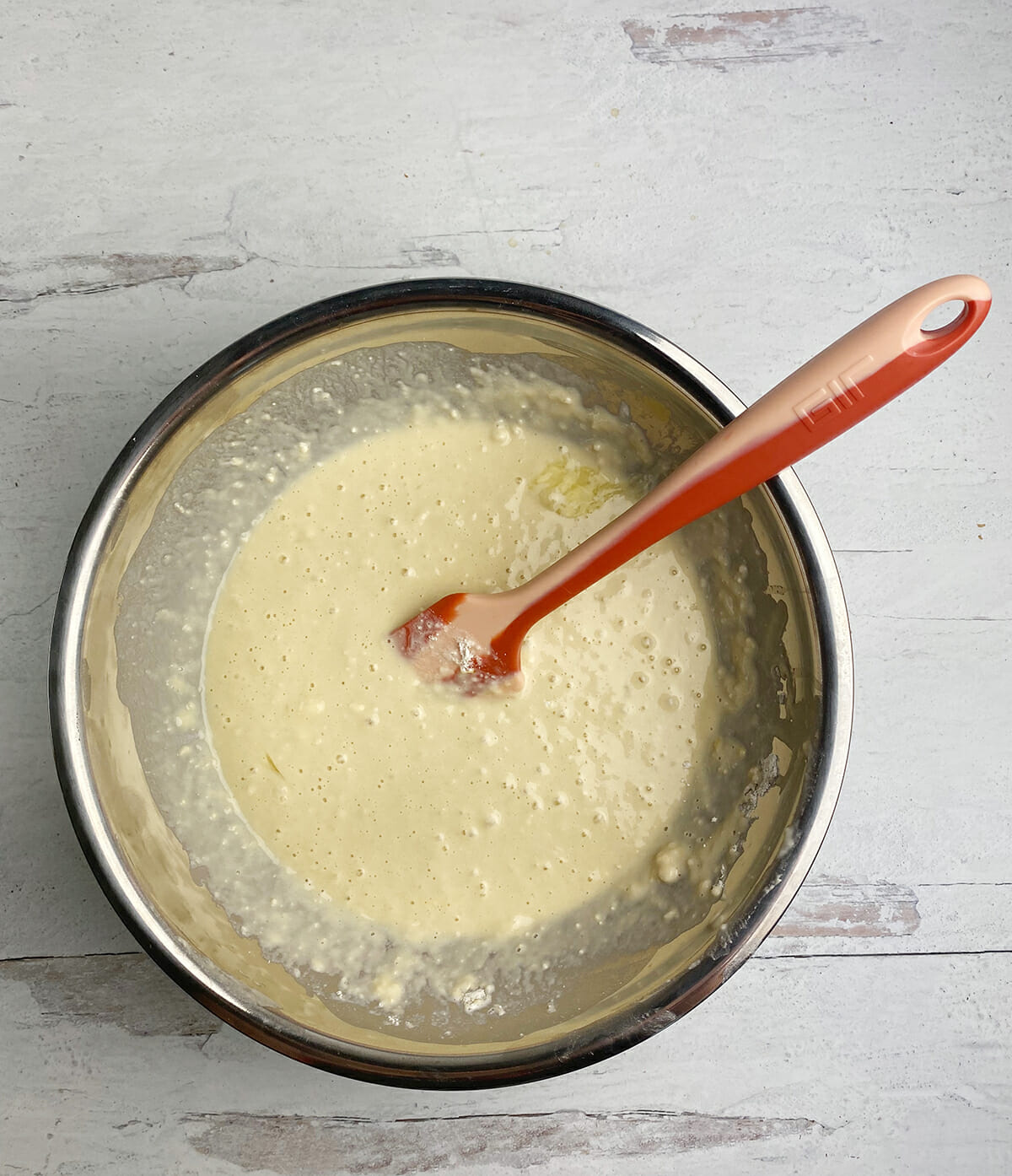 Pancake batter for onion rings in a mixing bowl.