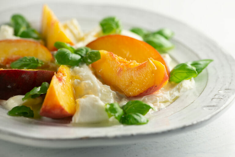 Peach mozzarella salad on a plate.