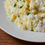 Soft scrambled eggs with ricotta on a plate.