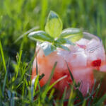 Strawberry basil margarita in the grass.