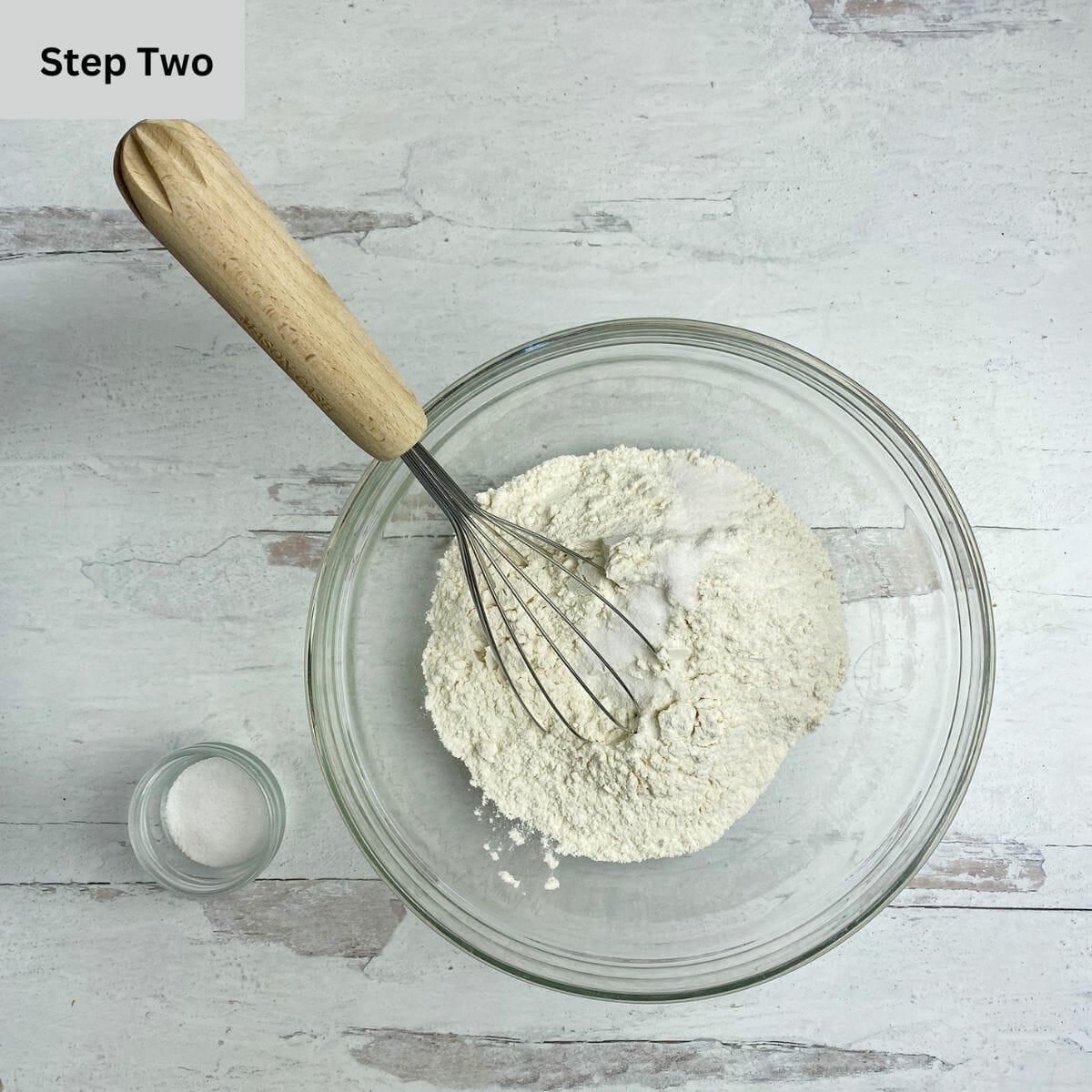 Flour and salt in a mixing bowl with a whisk.