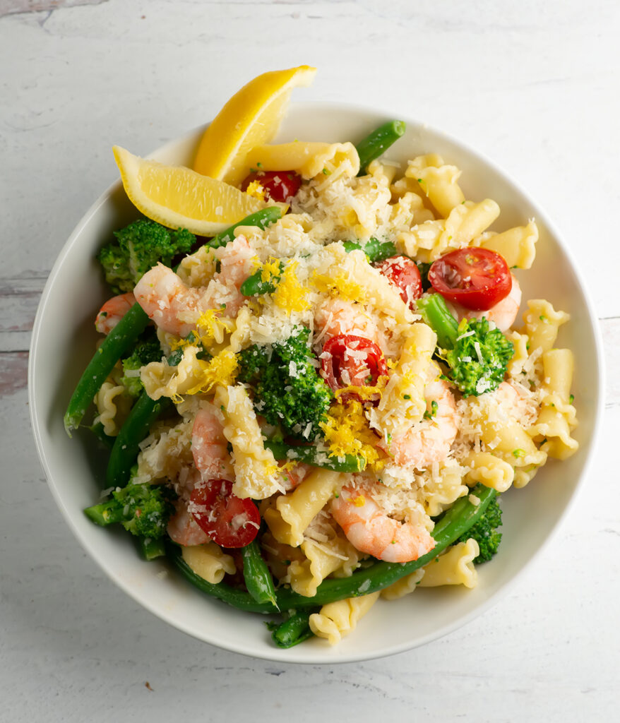 Bowl of shrimp pasta primavera.