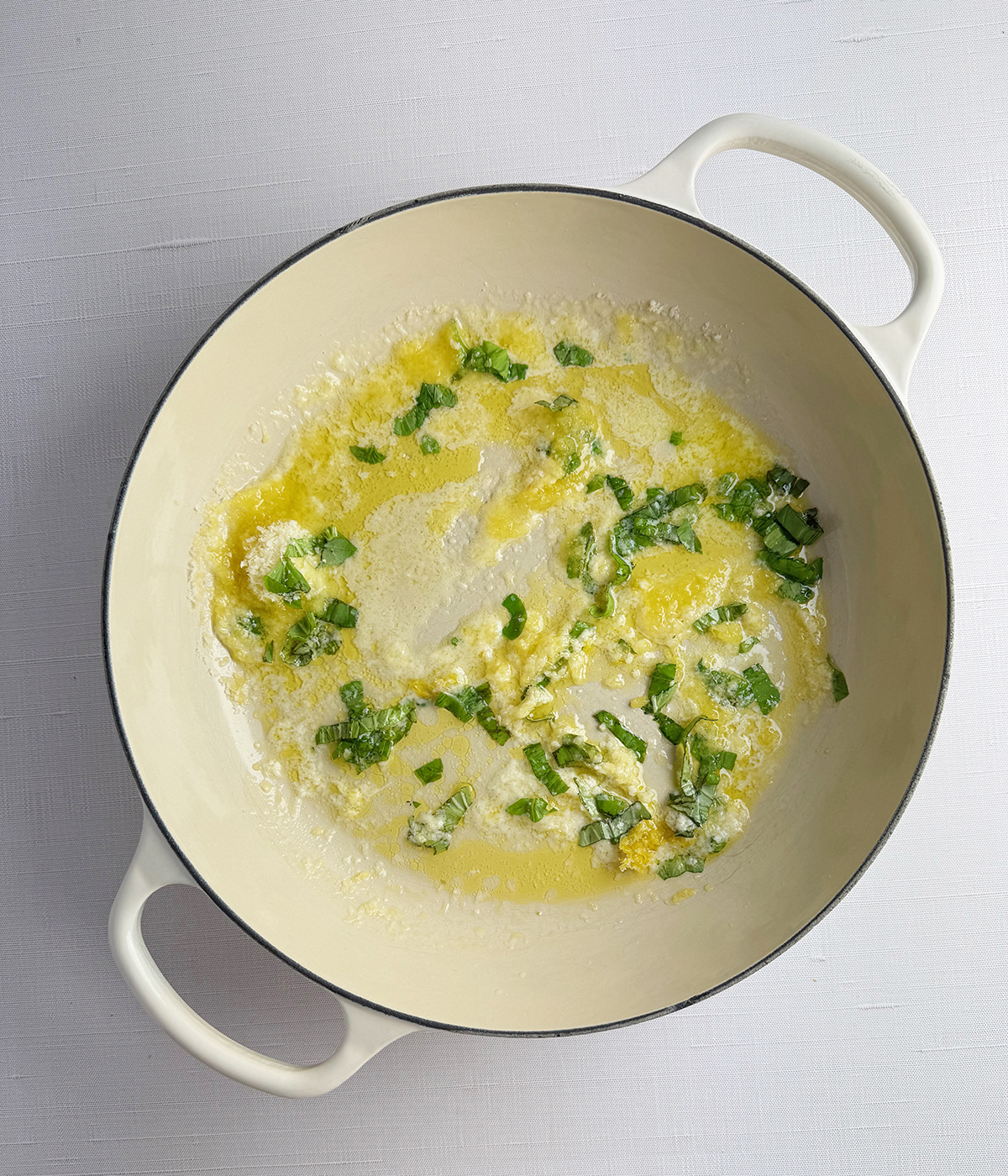 Butter and herb mixture in a skillet.