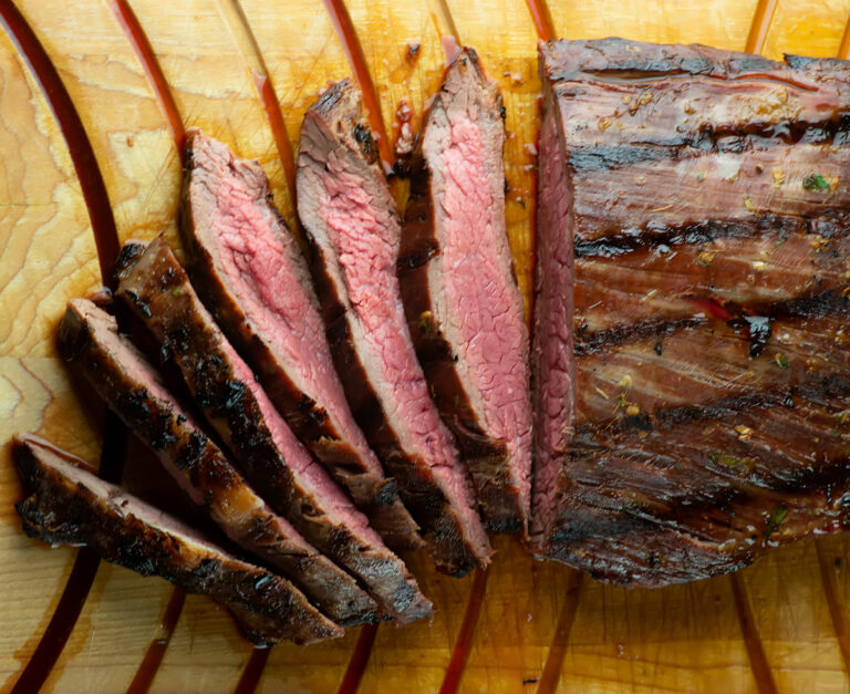 Rum steak on a cutting board.