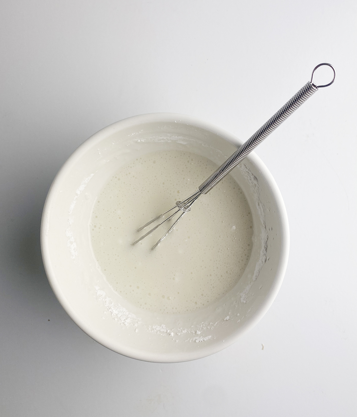 Vanilla glaze in a mixing bowl.
