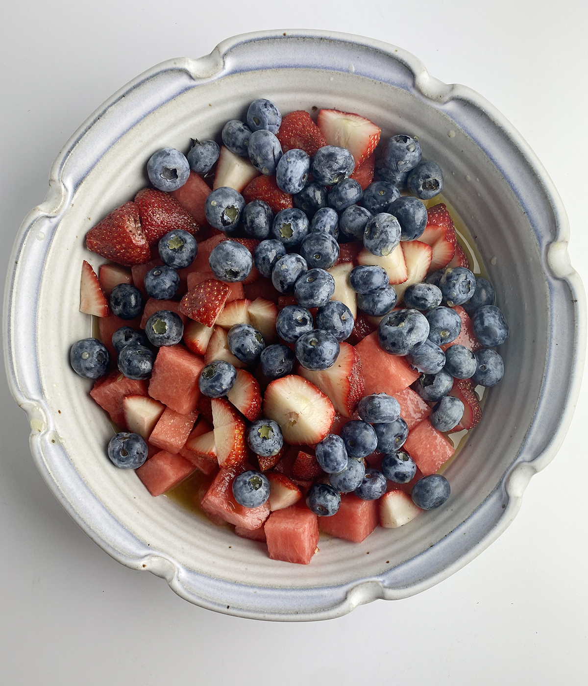 Watermelon strawberries and blueberries mixed in a bowl.