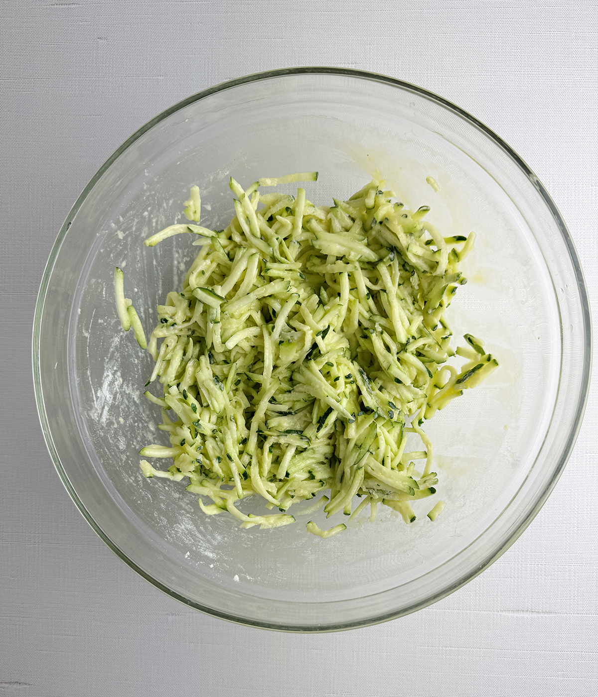 Zucchini fritter mixture in a bowl.