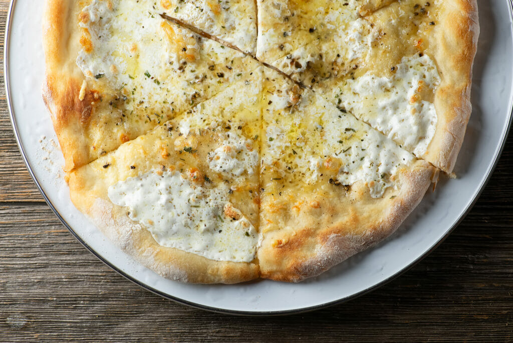 Slices of Honey Cheese Pizza on a plate.