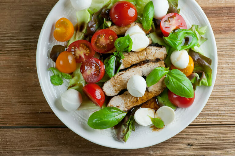 Caprese chicken salad on a plate.