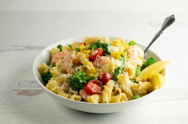 Shrimp pasta primavera in a bowl.