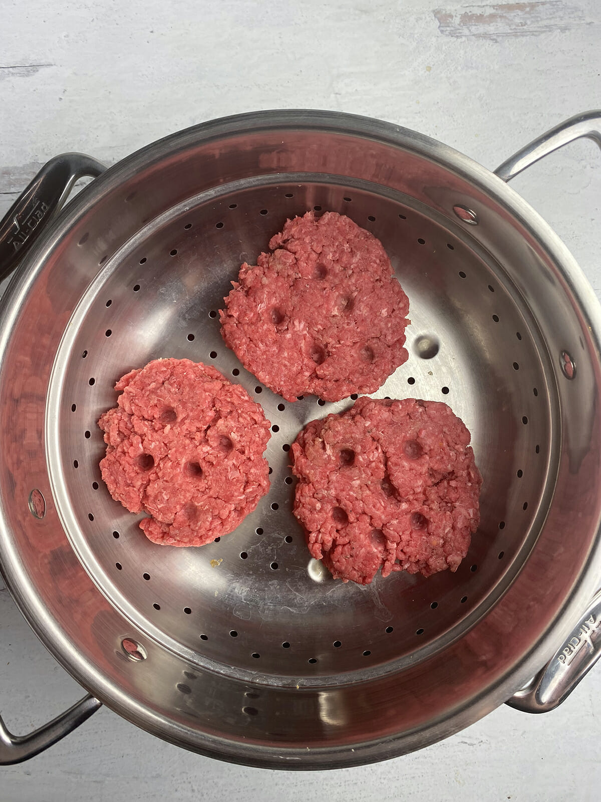 steamed cheeseburgers ready in the steamer