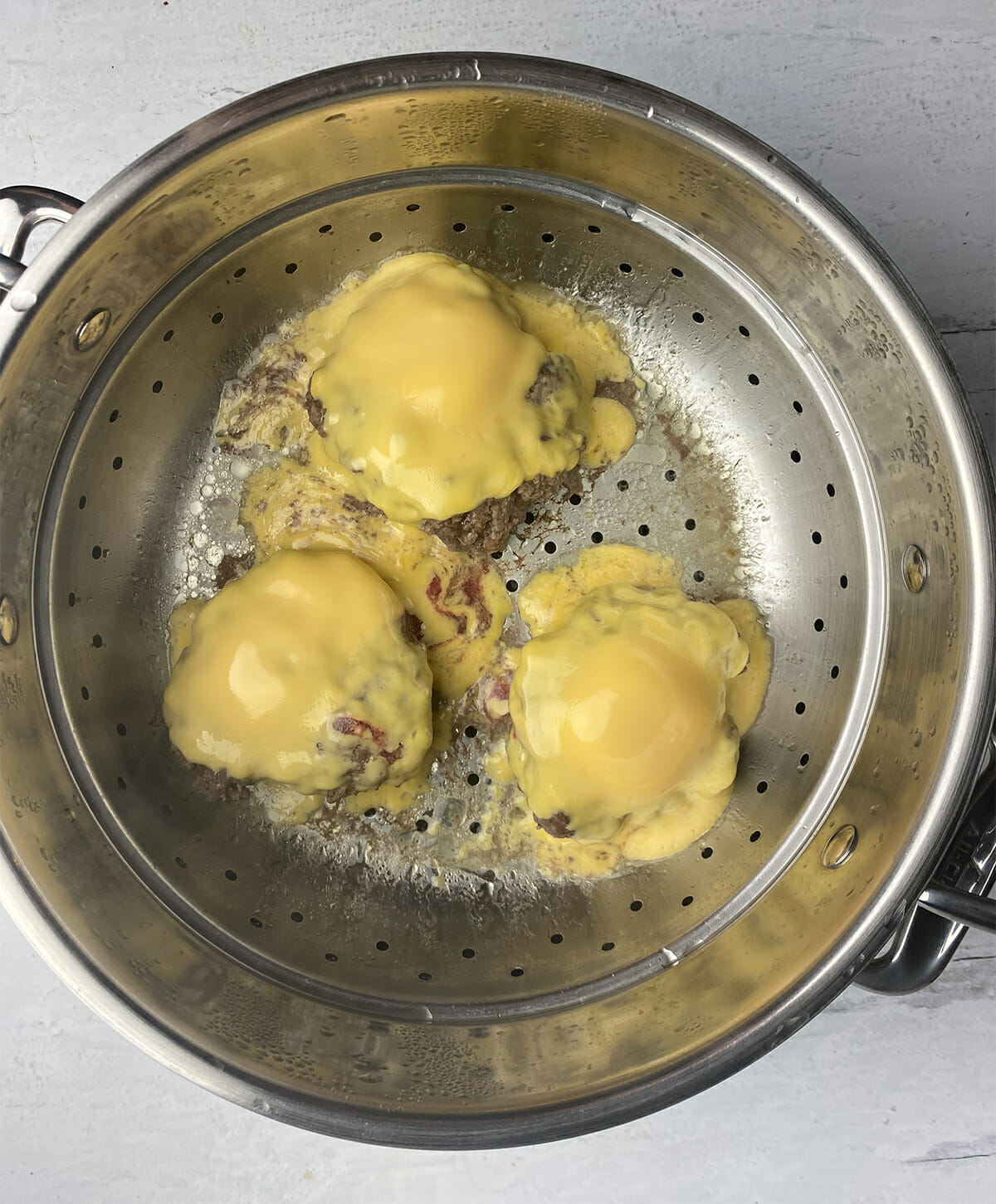 Steamed cheeseburgers with cheese in the steamer.