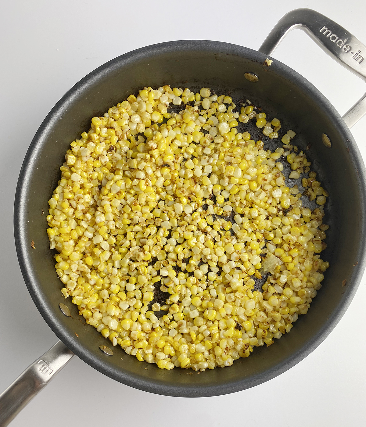 Browned corn in a skillet.
