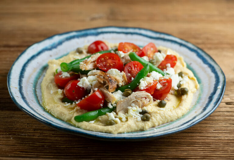 Chicken Hummus Bowls on a wooden counter.
