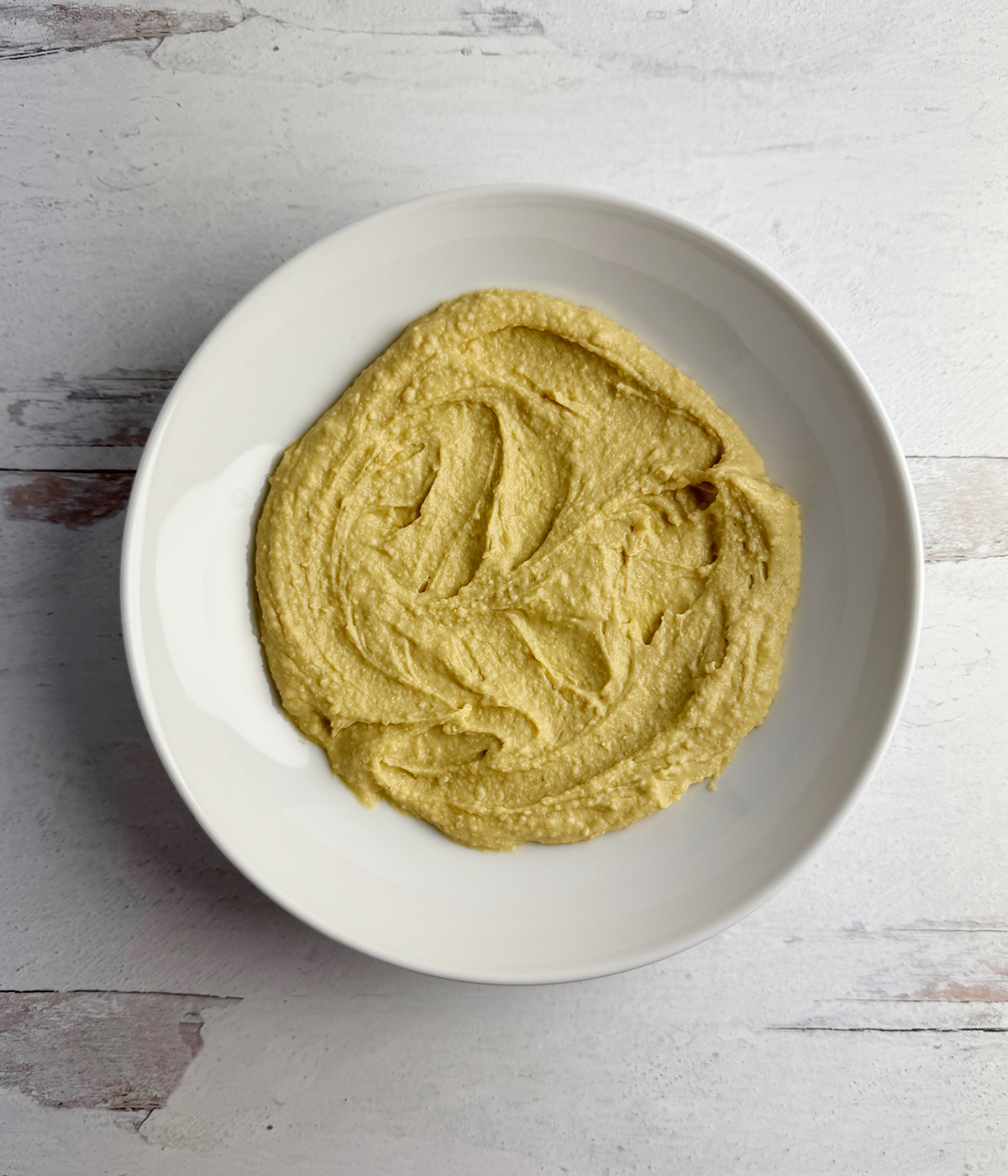 Hummus spread in a bowl.