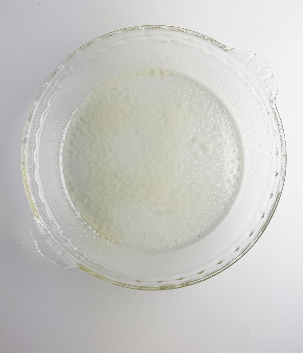 Pie plate with cooking spray.