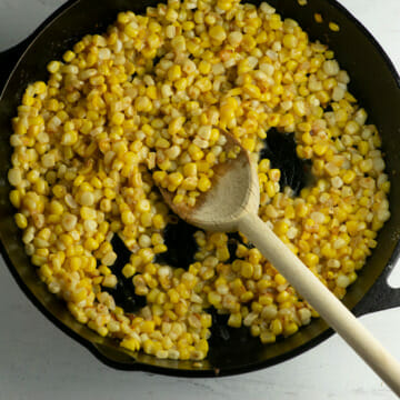 Cooked skillet corn in a cast iron skillet.