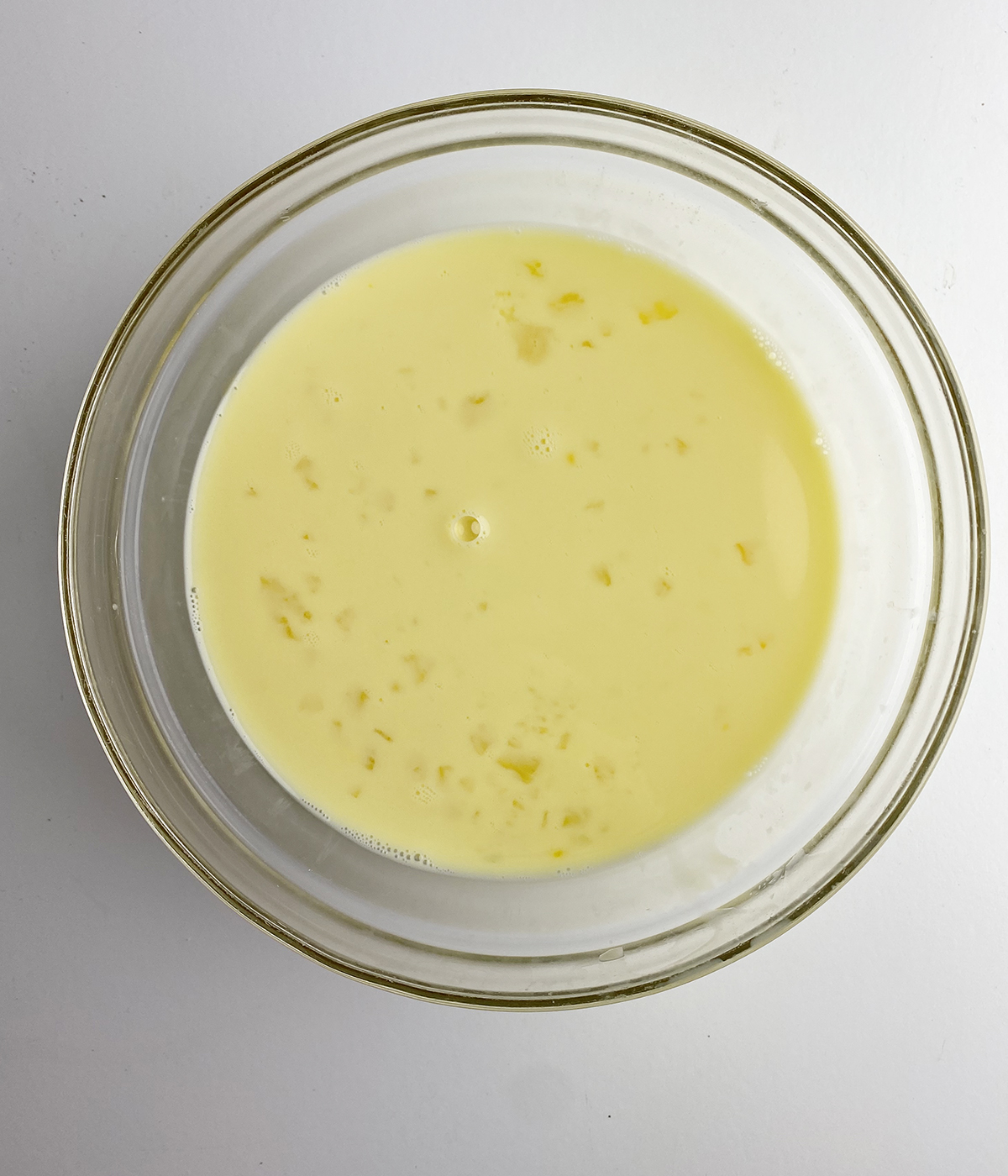 Beaten egg and milk in a mixing bowl.