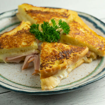 French Toast Grilled Ham and Cheese Sandwiches on a plate.