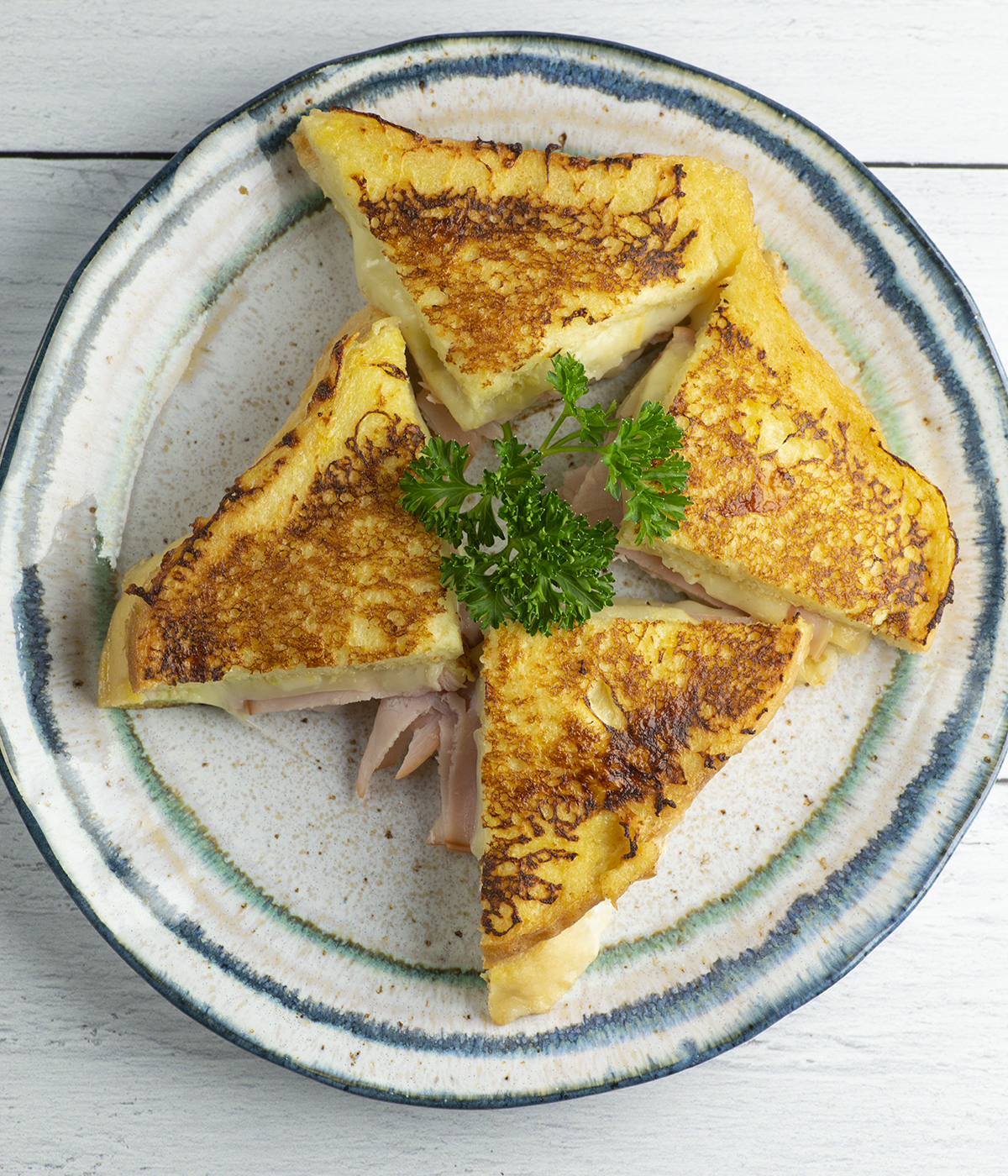 French toast grilled cheese sandwich on a plate.