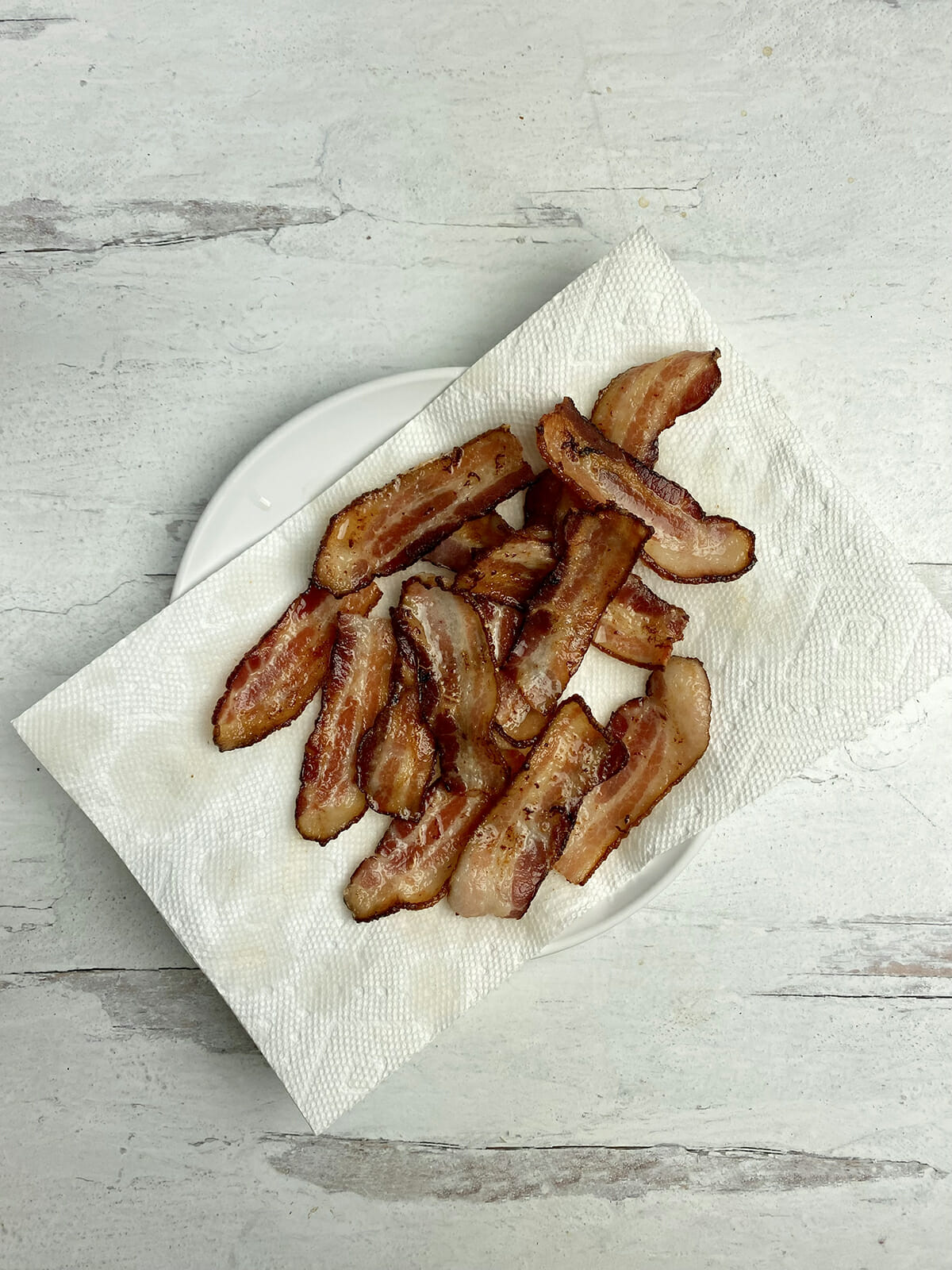 Bacon draining on paper towels.