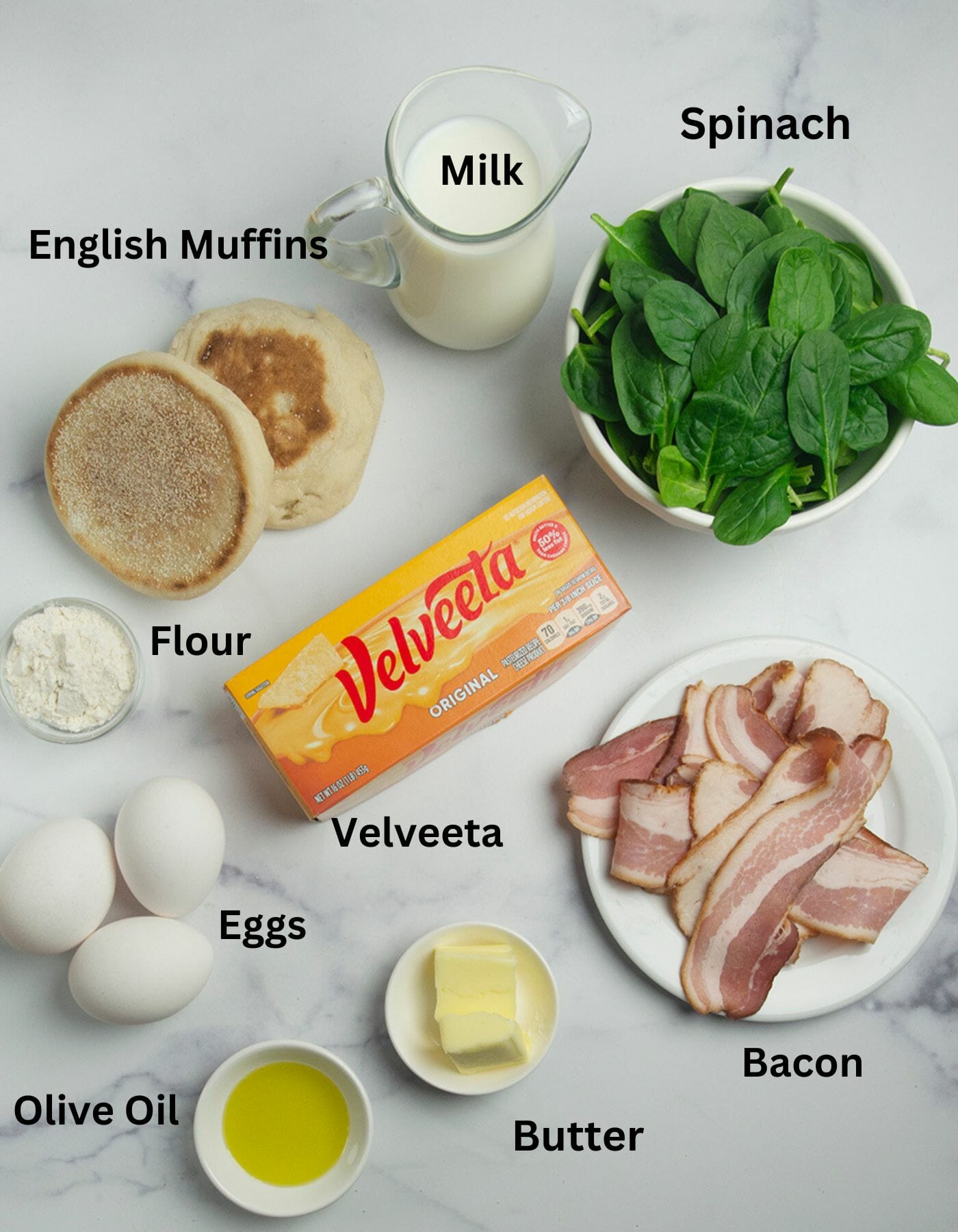 Best breakfast sandwich ingredients on a marble counter.