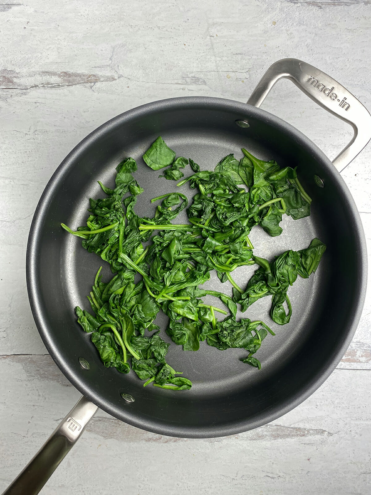 Cooked spinach in a pan.