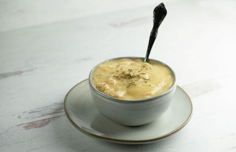 Hearty Chicken Cauliflower Soup in a bowl with a spoon.