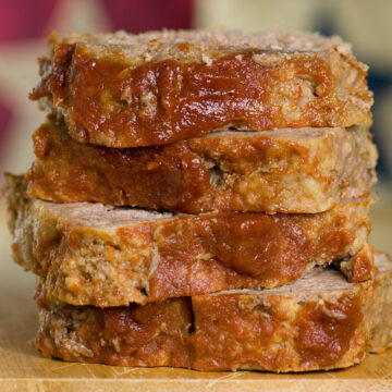 Brown sugar meatloaf slices in a stack.