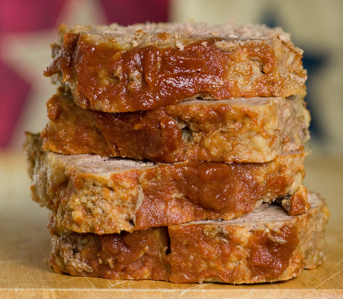 Brown sugar meatloaf slices in a stack.