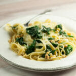 Pasta with creamed spinach sauce on a plate.