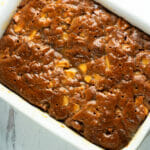 Sticky caramel apple cake in a casserole dish.