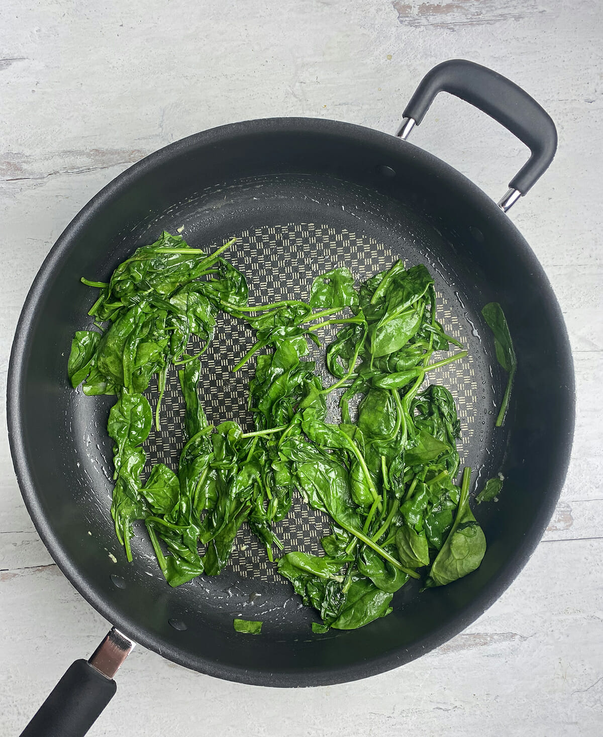 Sauteed spinach in a pan.