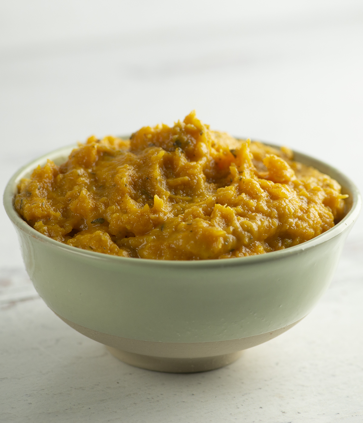 Mashed butternut squash in a bowl.