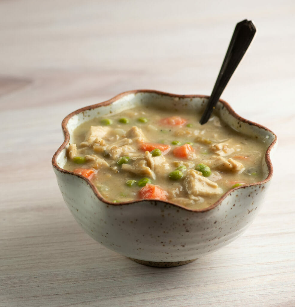 Thanksgiving leftovers soup in a bowl with a spoon.