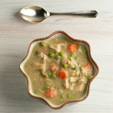 Thanksgiving leftovers soup in a bowl with a spoon.