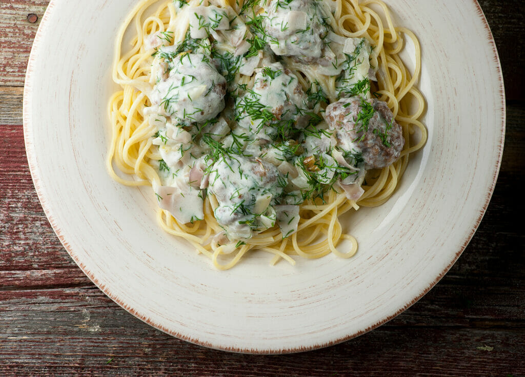 Beef Stroganoff Spaghetti and Meatballs on a plate.