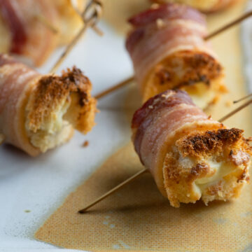 Bacon cheese rolls on a plate.