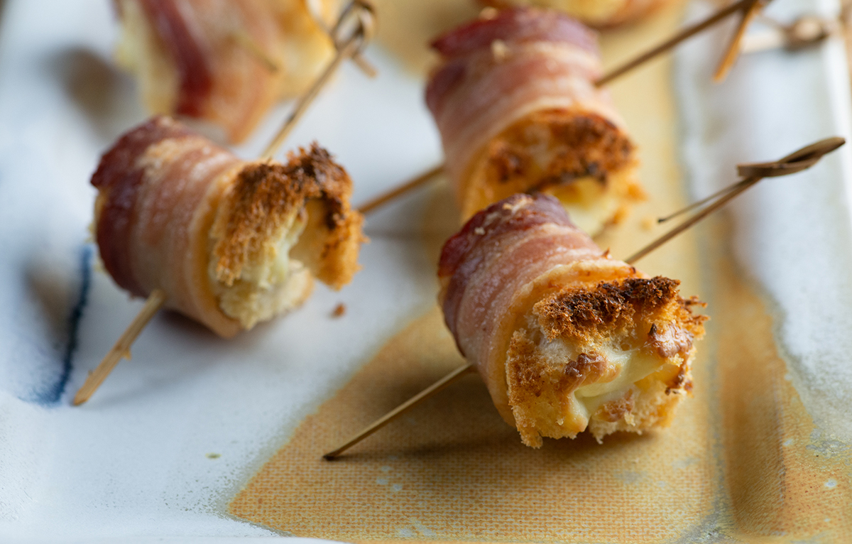 Bacon cheese rolls on a plate.