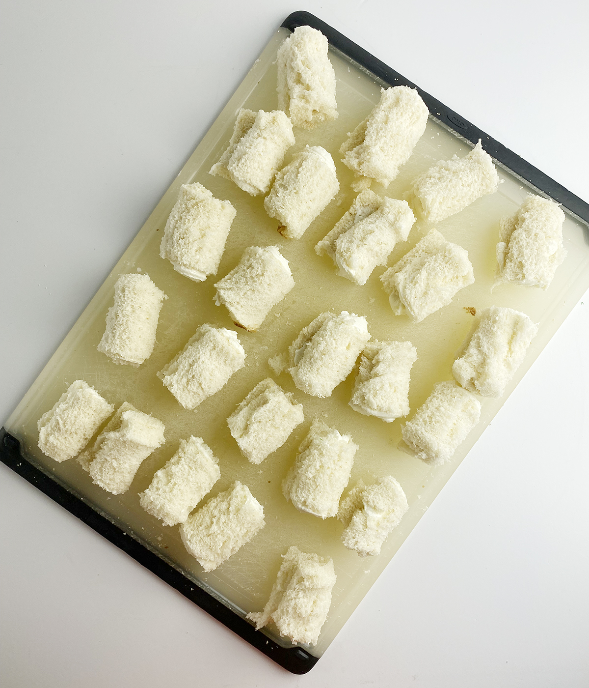 Cheese rolls on a cutting board.
