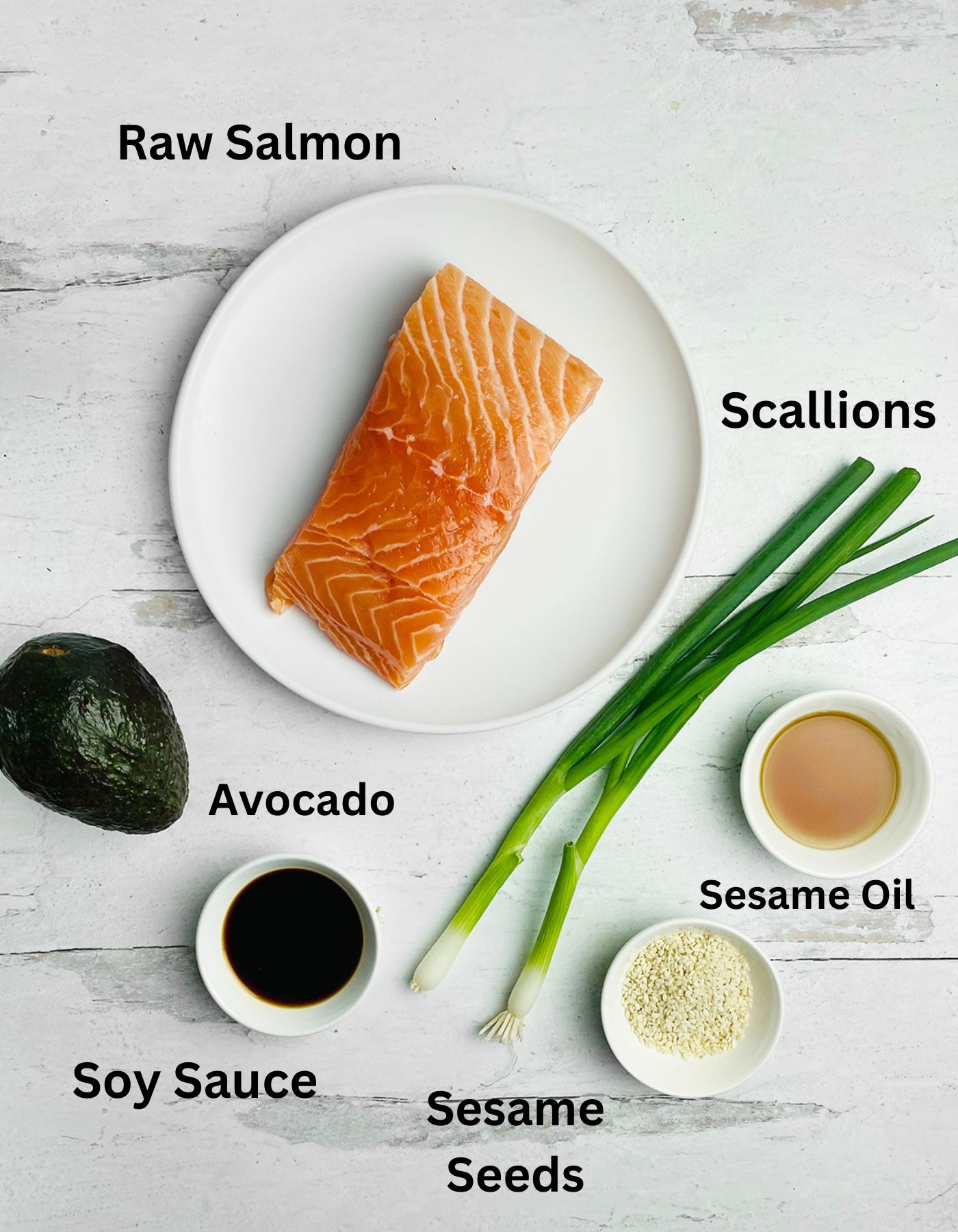 Salmon tartare ingredients on a wooden counter.