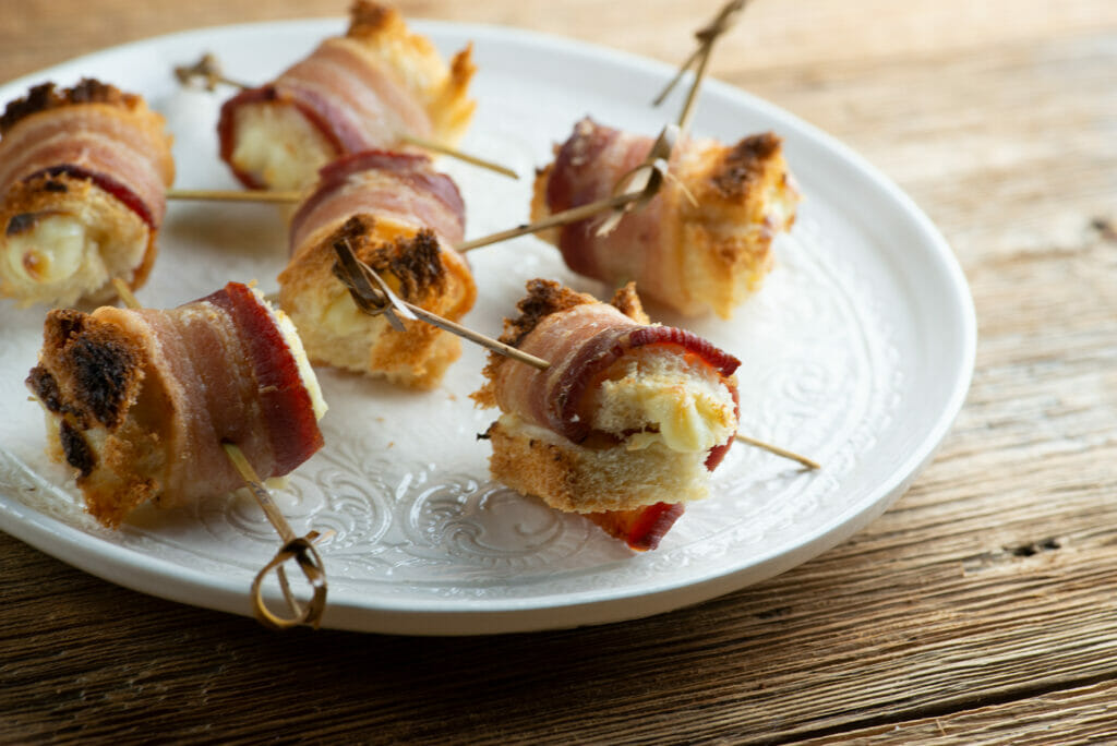 Bacon cheese rolls on a plate.