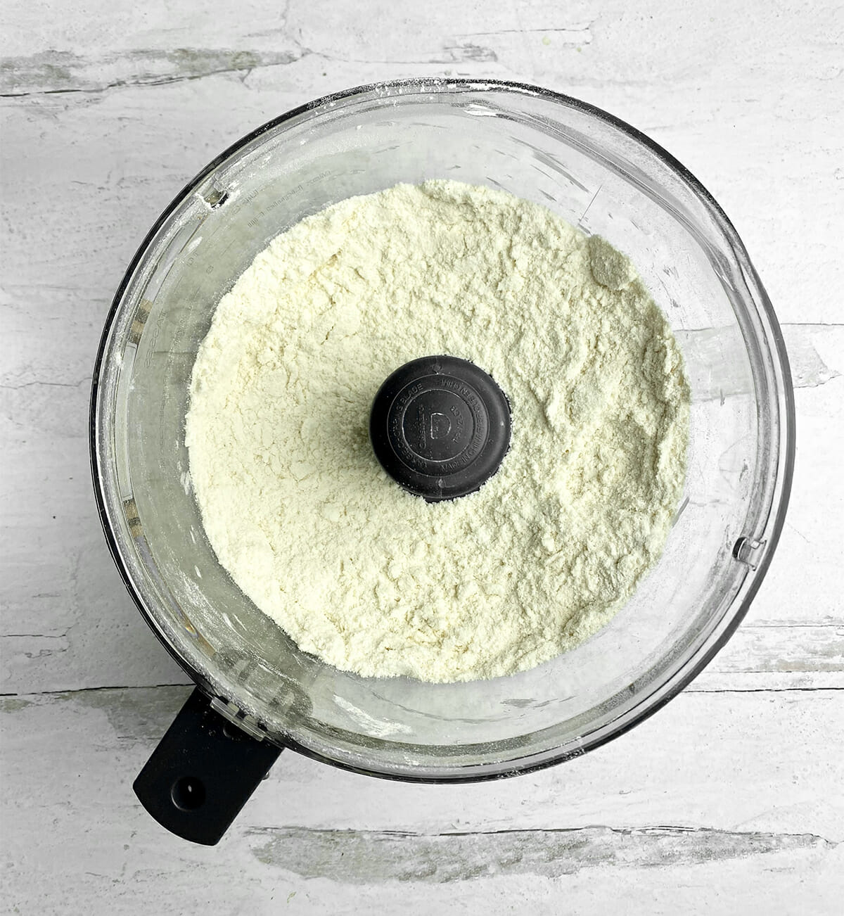 Jam cake dry ingredients in a food processor bowl.