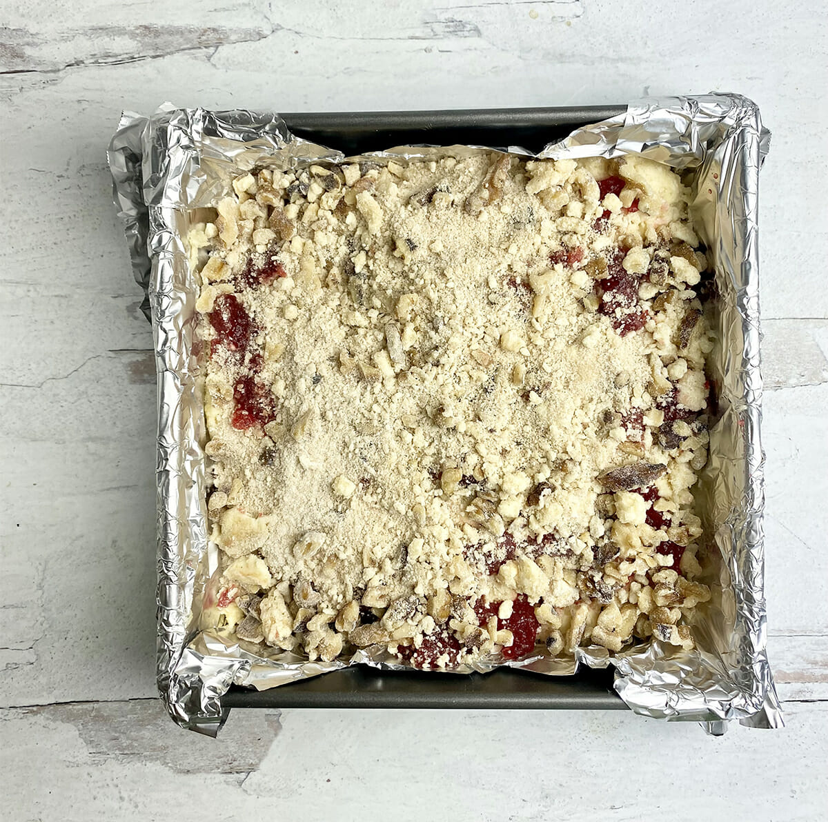 Jam cake with topping ready for the oven.